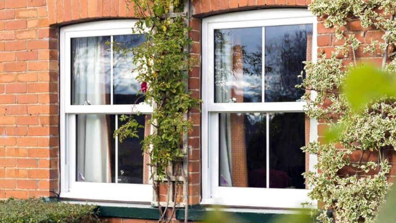 White uPVC sash Safestyle double glazing windows installed in a brick house