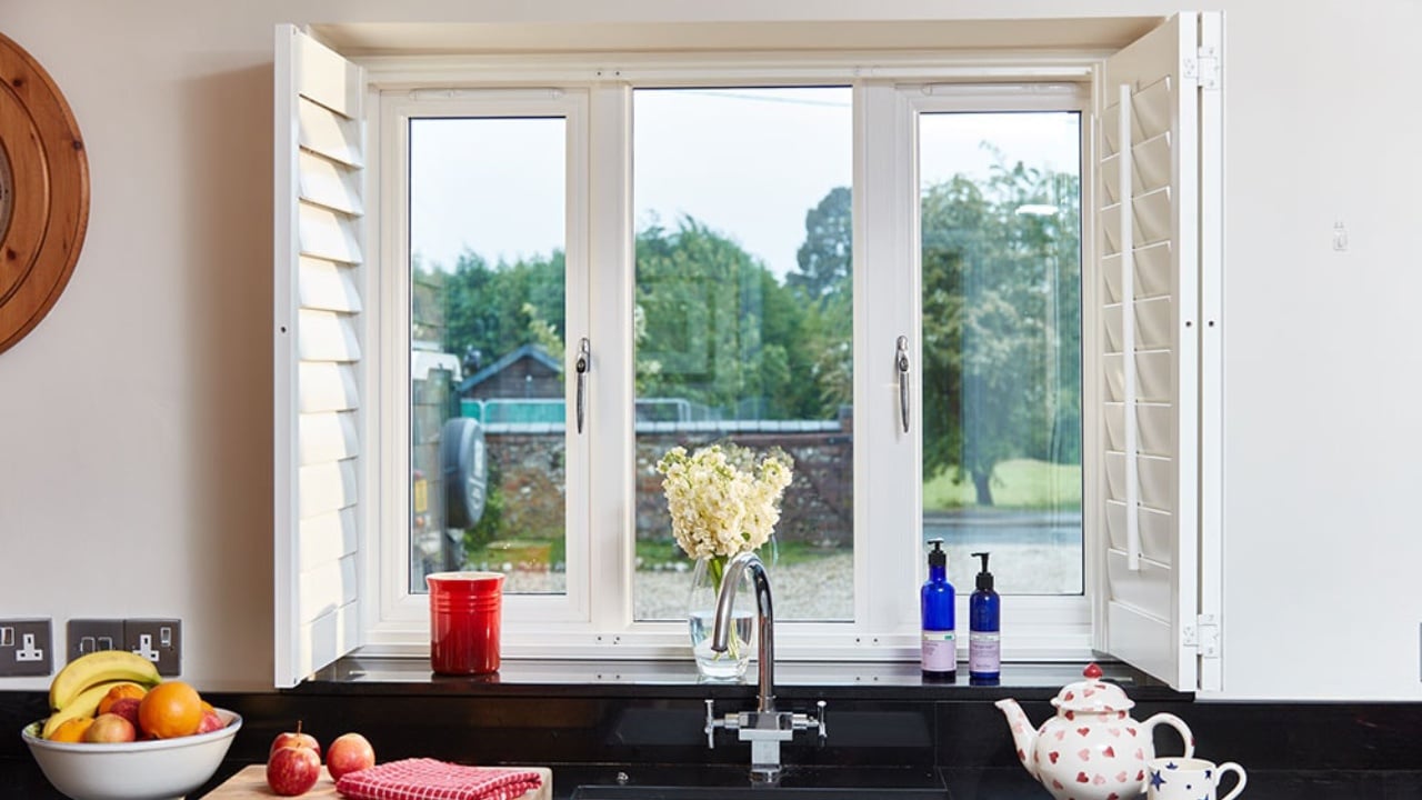 Anglian vs Everest. An Anglian double glazing window in white uPVC in a bright kitchen.