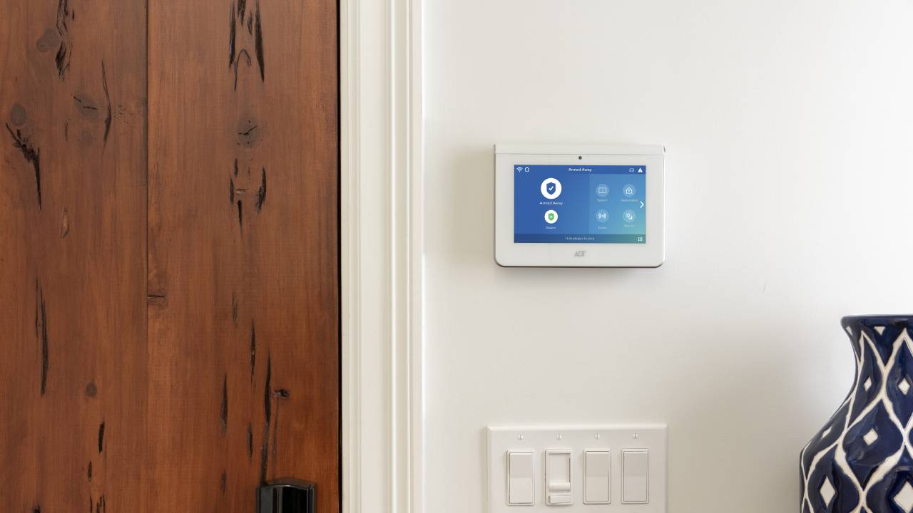 ADT home security system control panel on wall