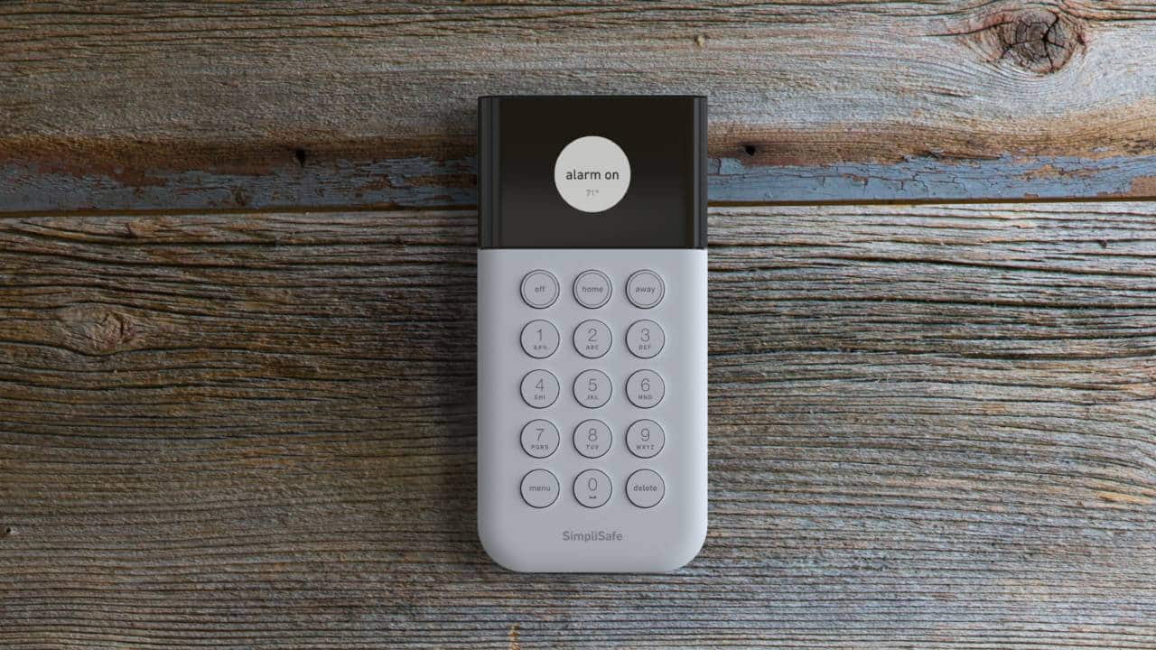 Simplisafe home security keypad on wooden table